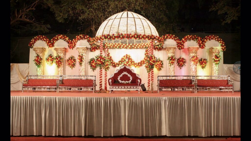A lavish wedding stage adorned with vibrant flowers and elegant decorations, embodying a regal theme for a memorable celebration.